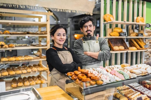 Dueños de una panadería felices por el crecimiento de su negocio tras solicitar un crédito de libre inversión.